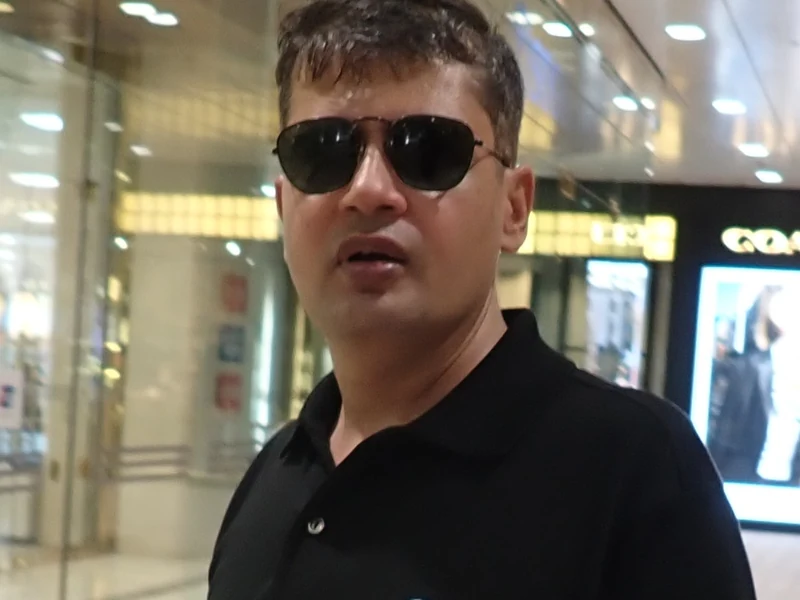 Indoor portrait of Dr. Ram C. Sharma wearing dark sunglasses.