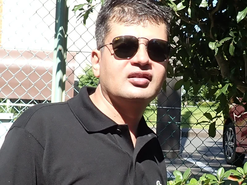 Outdoor close portrait of Dr. Ram C. Sharma wearing sunglasses.